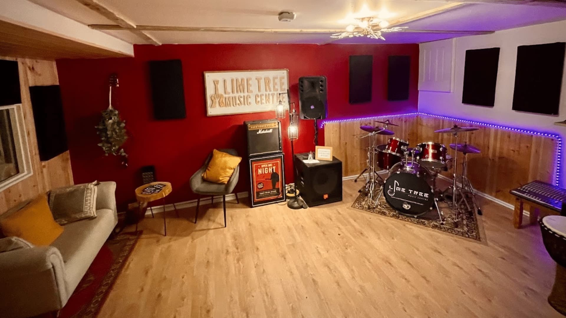 The rehearsal room at Lime Tree Music Centre, with the drum kit, amps, PA speakers and a sofa
