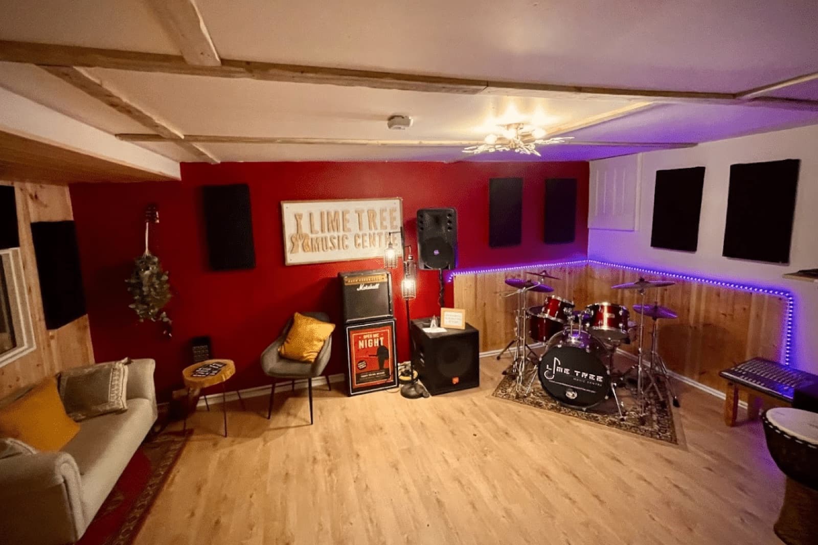 The rehearsal room at Lime Tree Music Centre, with the drum kit, amps, PA speakers and a sofa